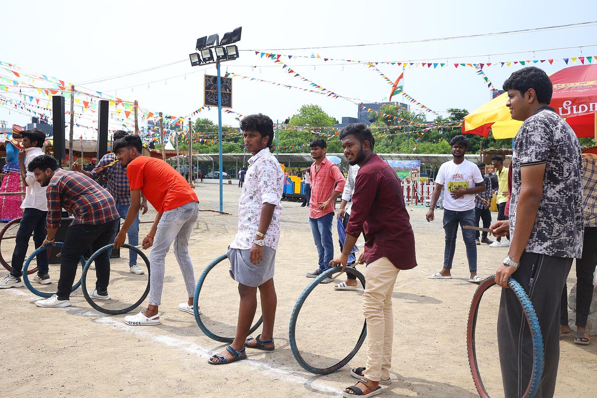 People take part in a tyre competition.