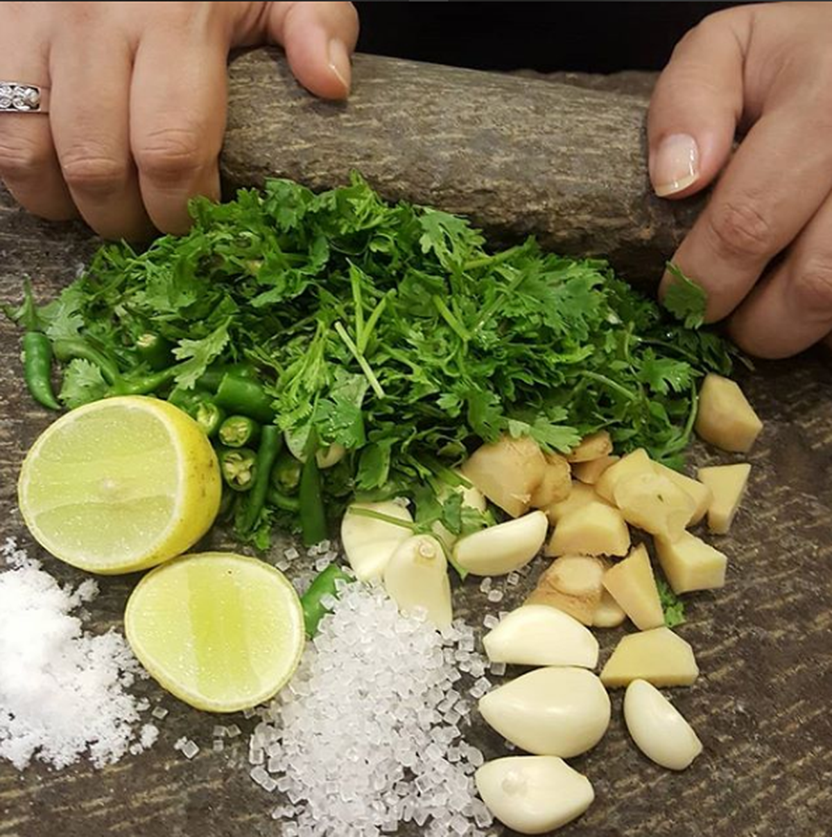 Coriander chutney being made on a silbatta