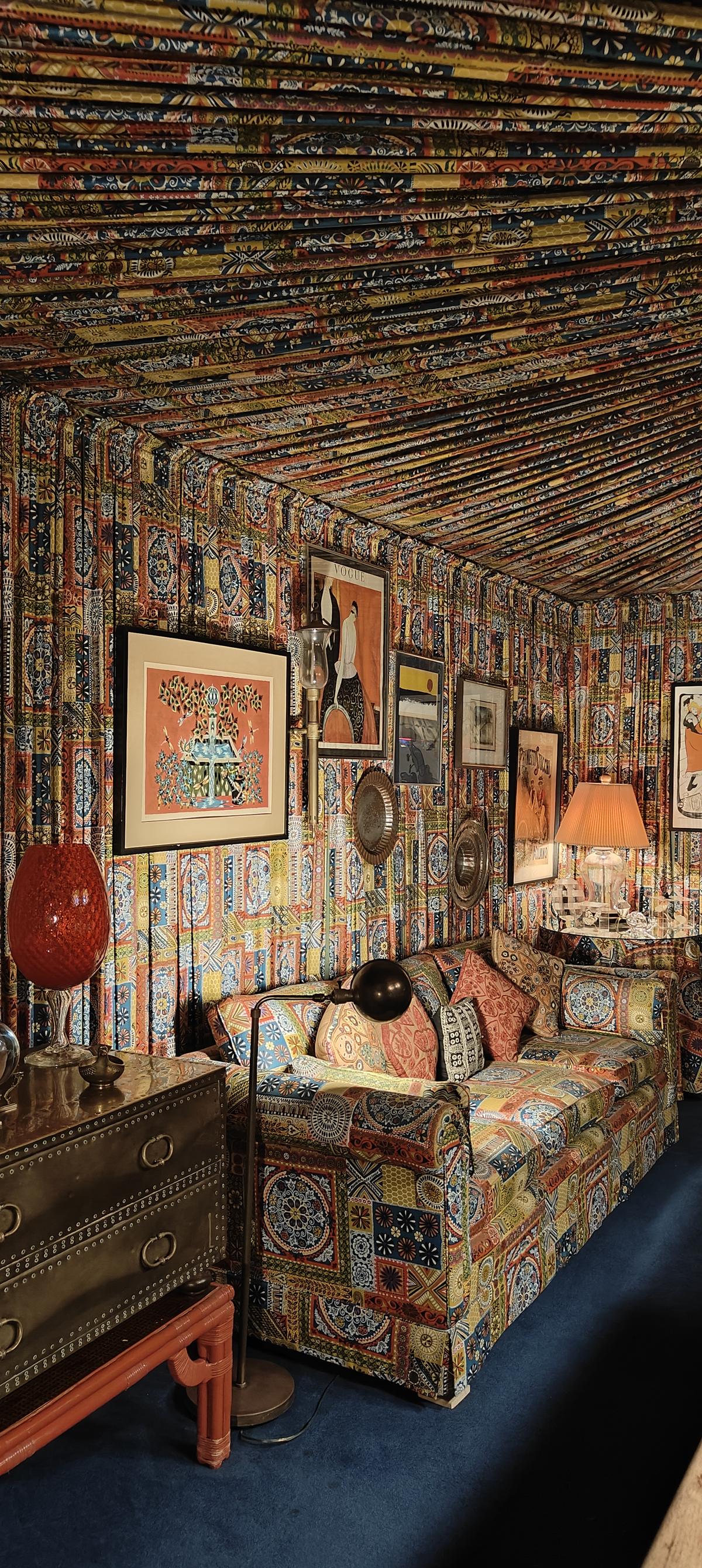 Jungle Room in Graceland is an unapologetically kitschy fever dream of green shag carpets, heavy curtains, and ornately carved furniture.  