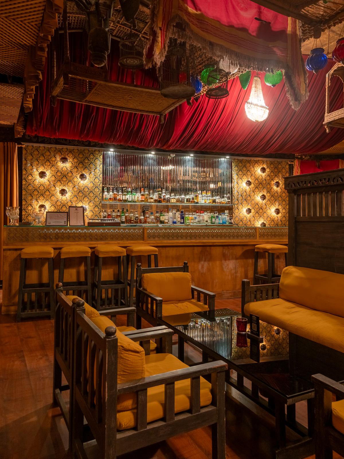 The J Bar at Ajit Bhawan features a ceiling strewn with palanquins, gleaming bird cages and polished kettles