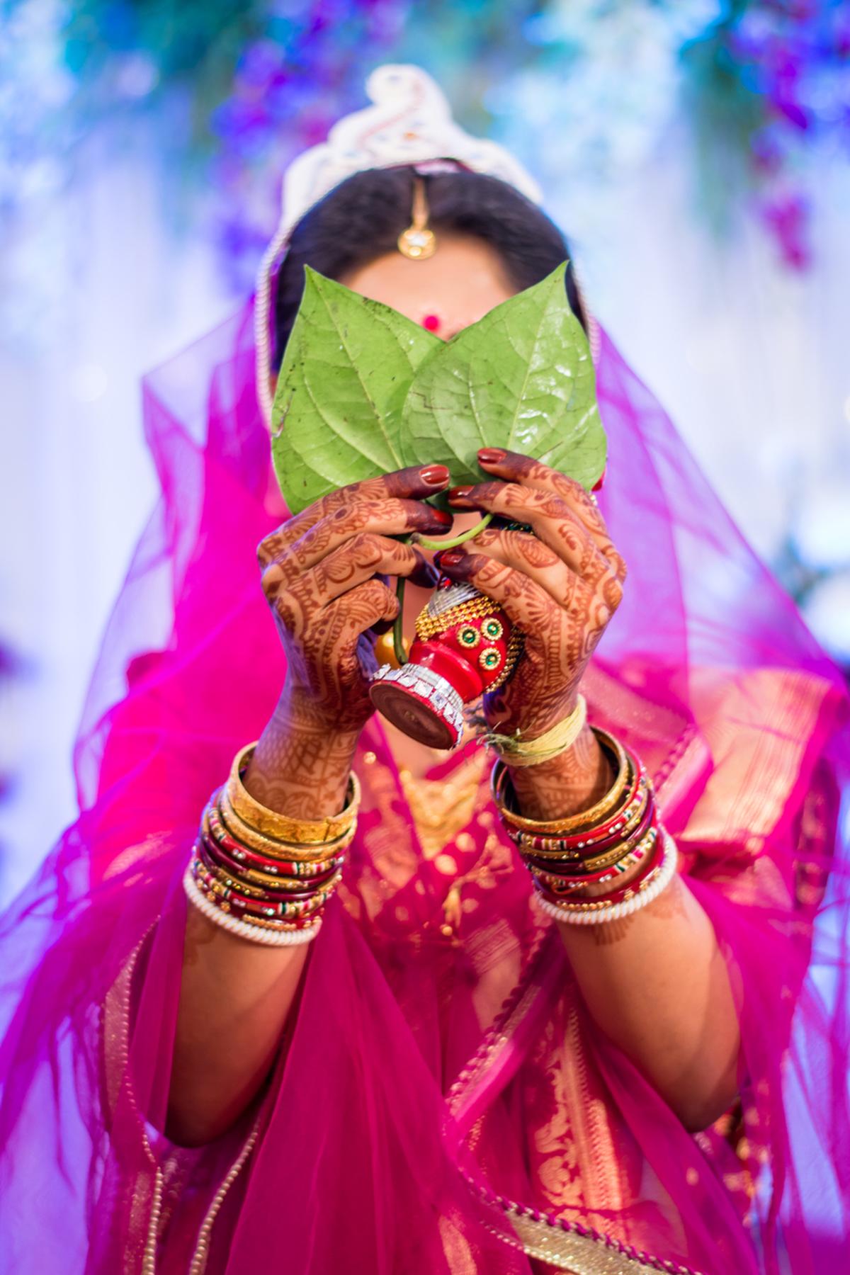 Beautiful bride performing Shubhodristi which is a Bengali culture wedding ritual done by the Bride in which she hides her face in front of the Groom. Beautiful bride performing Shubhodristi which is a Bengali culture wedding ritual done by the Bride in which she hides her face in front of the Groom.