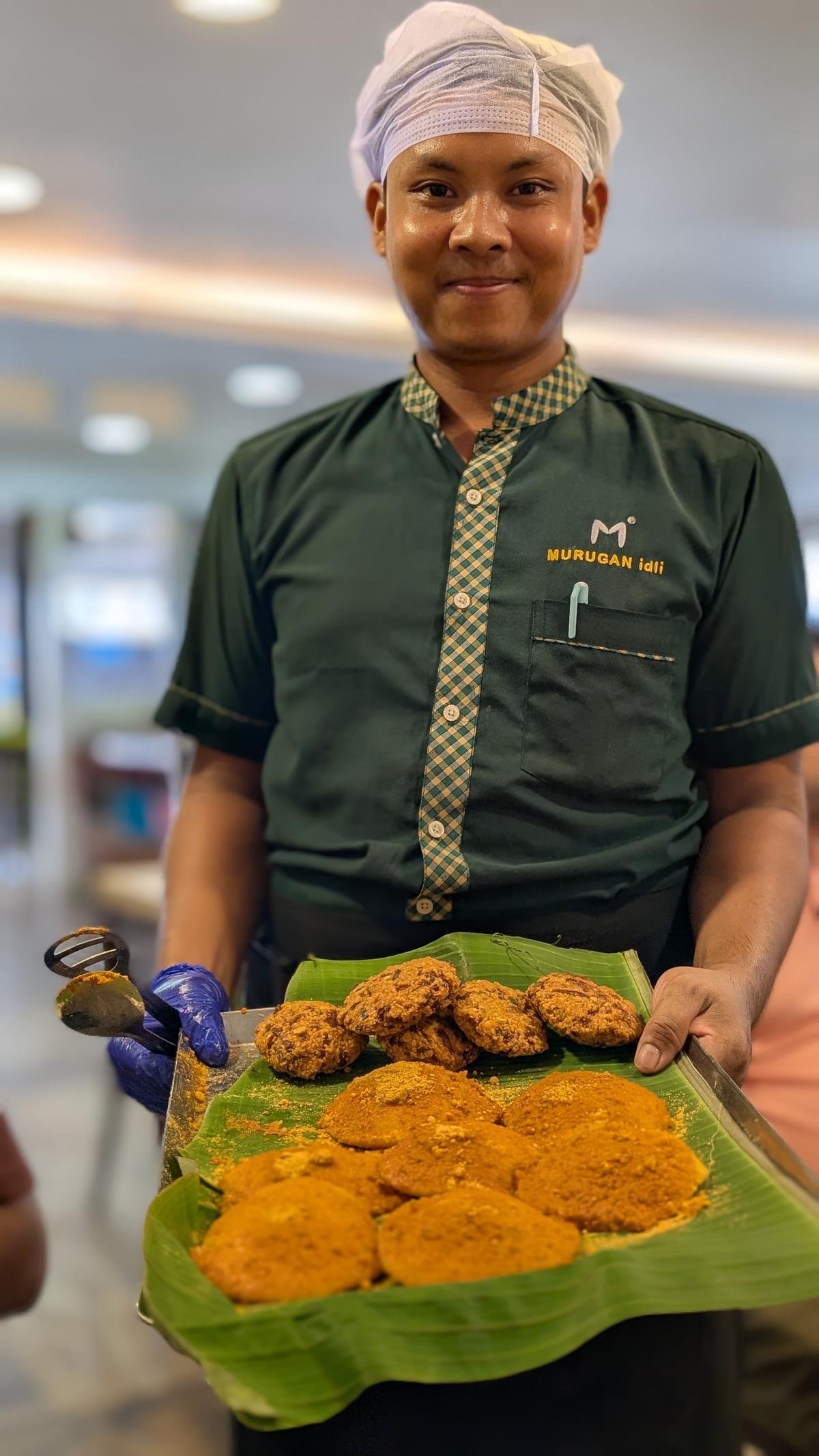 A server at Murugan Idli Shop