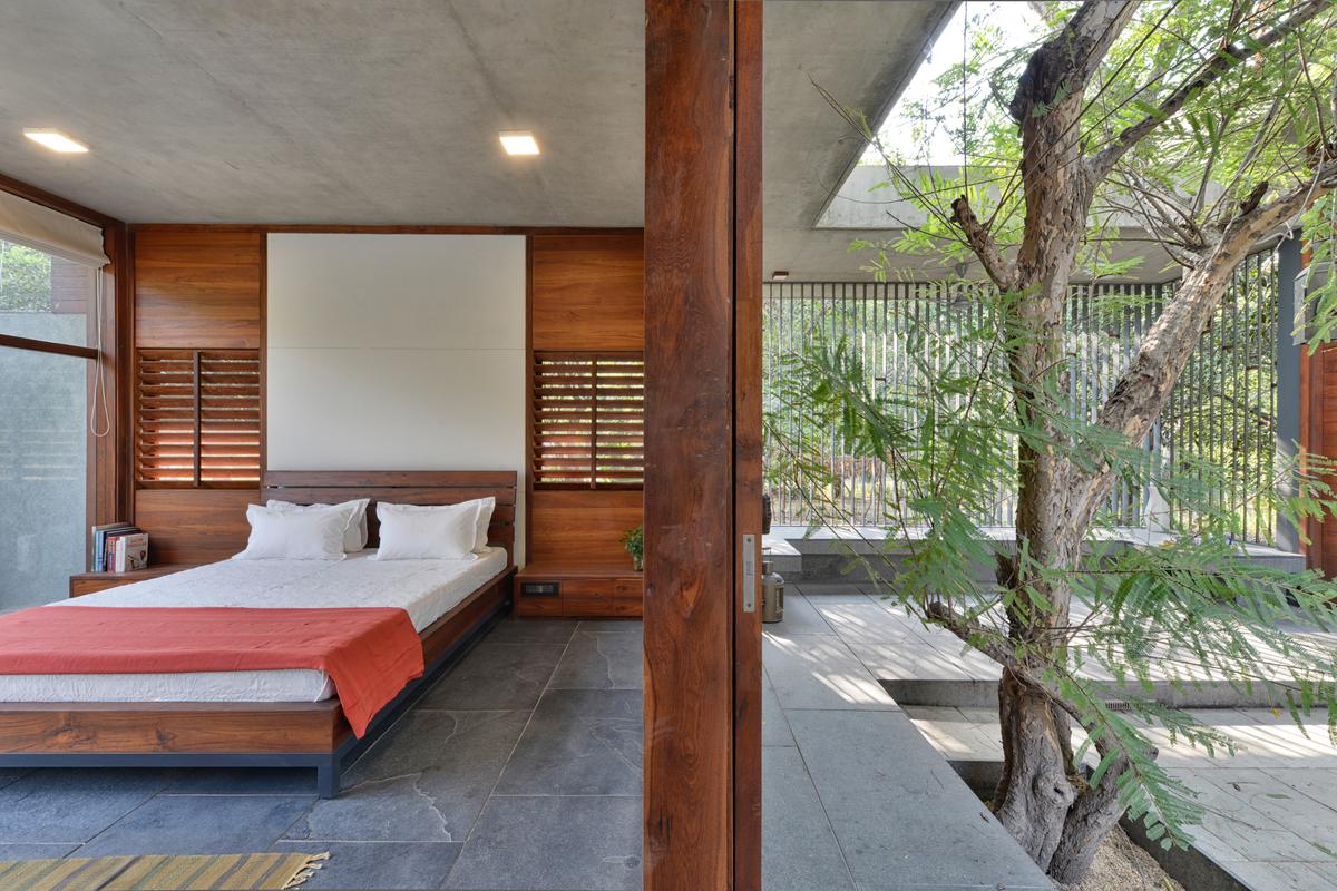 The living area in The House By The Trees is a glass box that allows the residents to be connected with the outdoors.