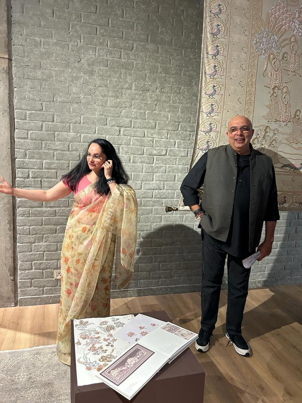 Anupama Kabra with Tarun at the atelier, with the restored Nottingham Pichwai in the background