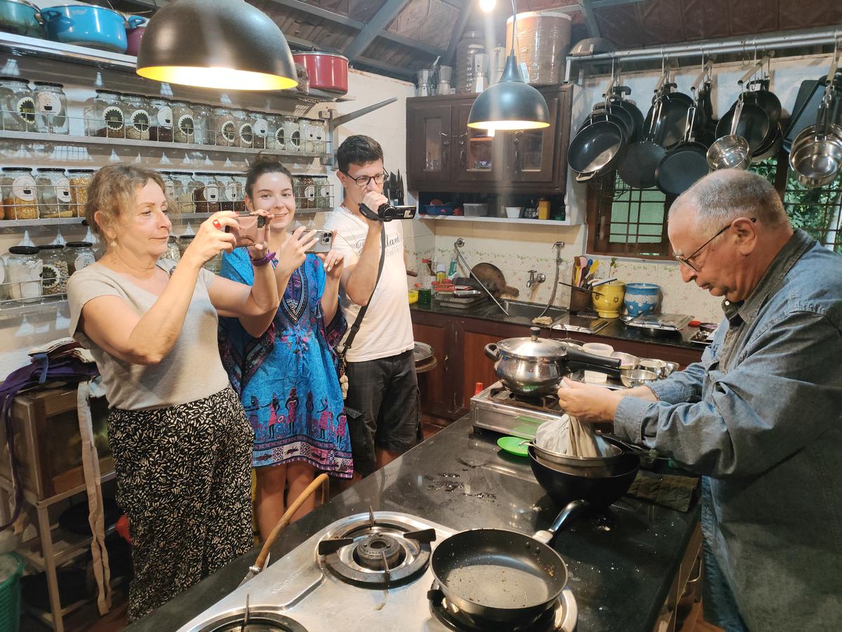 Tourists participate in a class at Haritha Farm’s Pimenta Spice Garden Bungalows