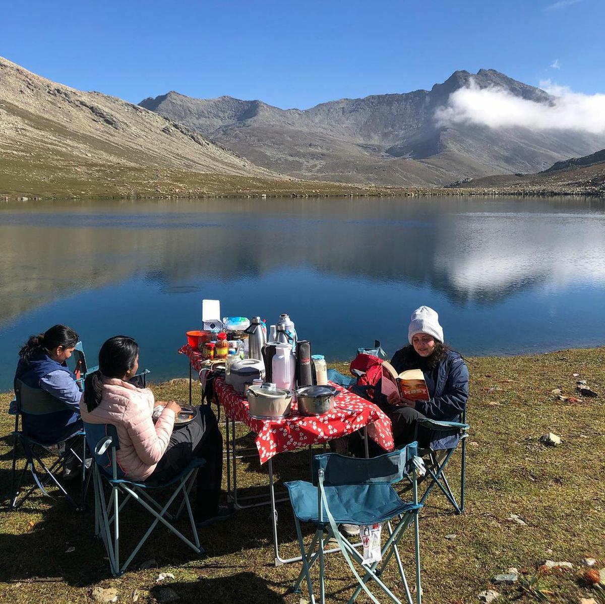 Reading by a lake in kashmir during a trek.