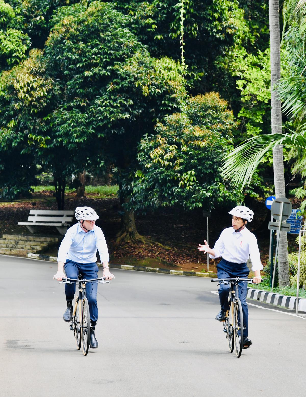 Indonesian President Joko Widodo (right) cycles with Australian prime minister Anthony Albanese in Bogor Presidential palace during the latter’s visit to the country.