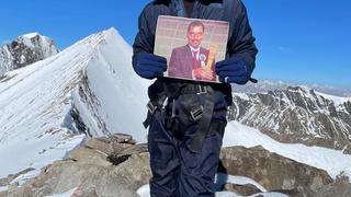 Rohit Rao holding his father’s portrait at Dzo Jongo