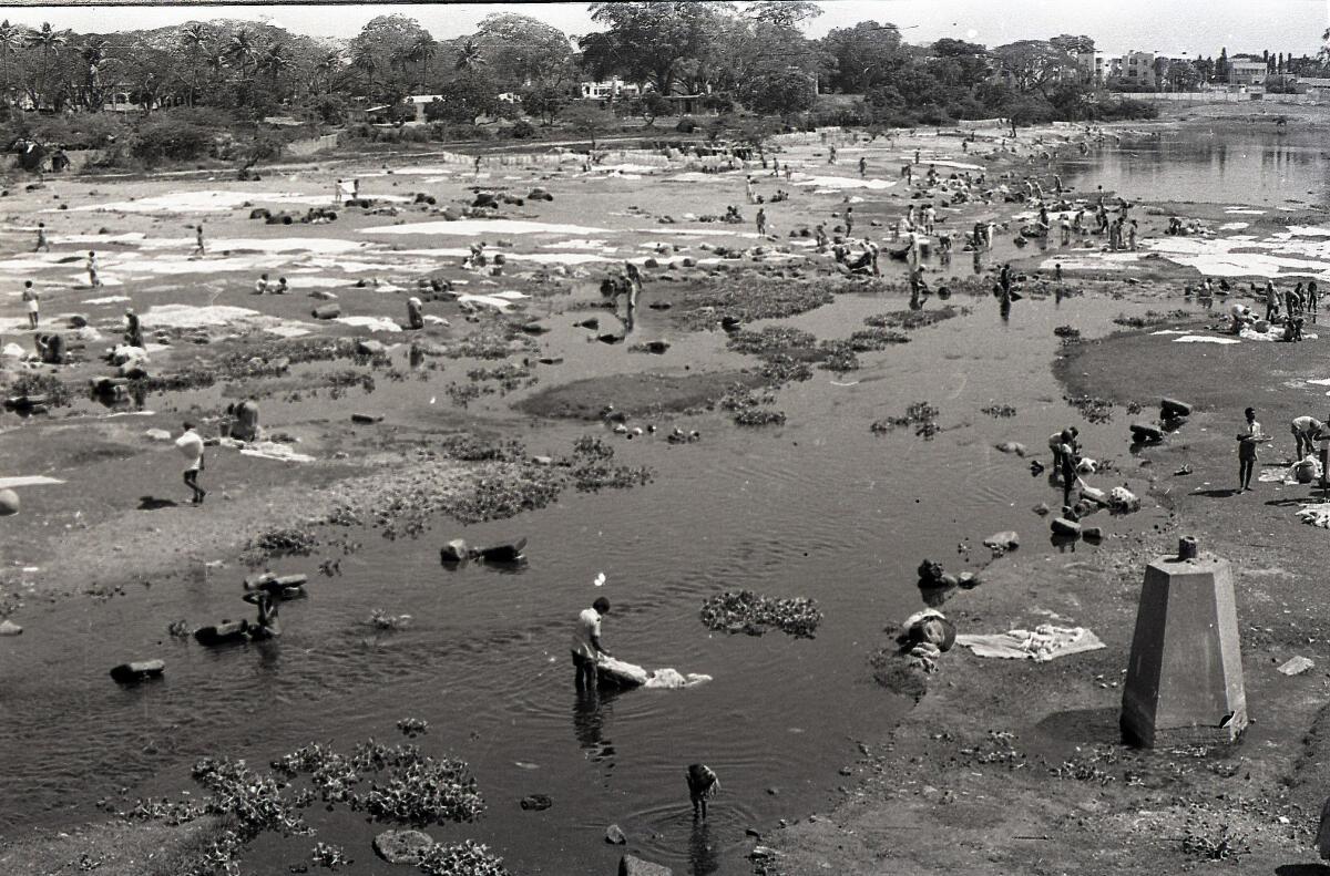 The Washerman washing the clothes at Dhobi Ghat on the Adyar river in Madras. (Circa March 1976). The Washerman washing the clothes at Dhobi Ghat on the Adyar river in Madras. (Circa March 1976).
