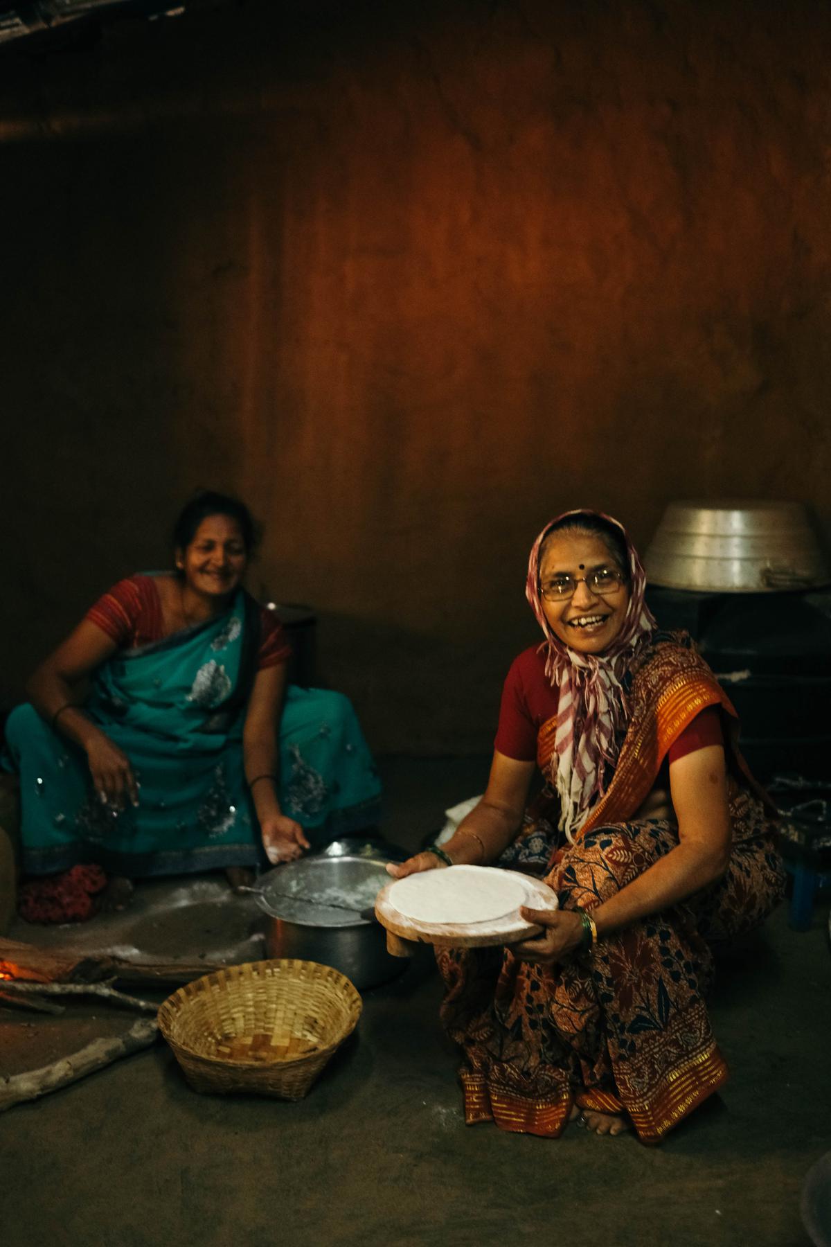 Women cooking tubers in their home in Joida, Karnataka