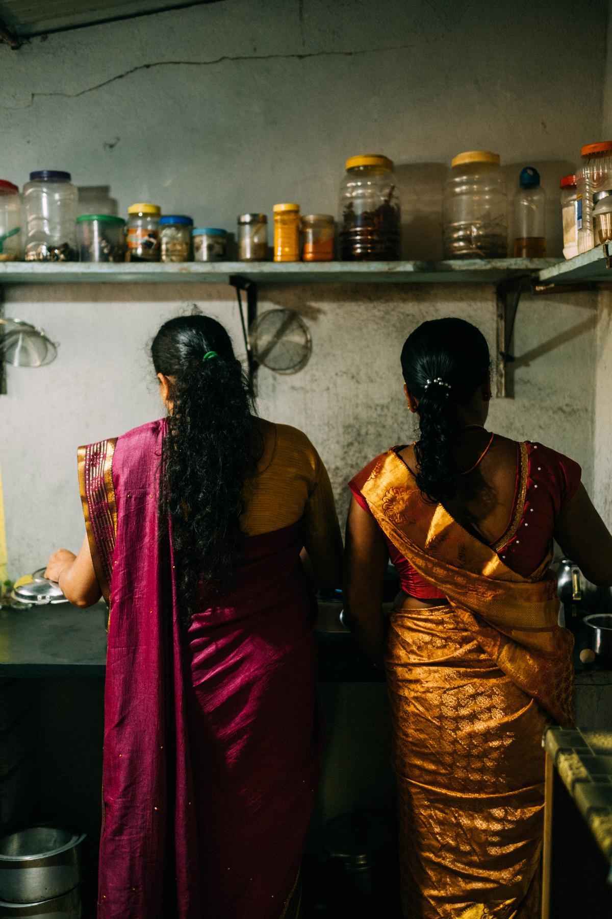 Kunbi women cooking tubers in their kitchen in Joida, Karnataka