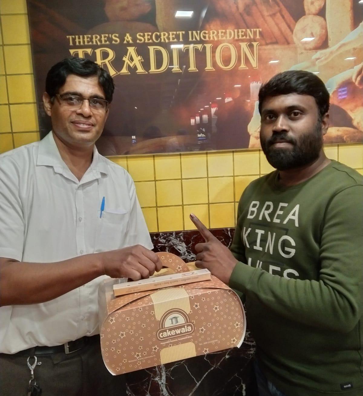 First time voter receiving free 500 gram cake after voting at Cakewala, Bengaluru
