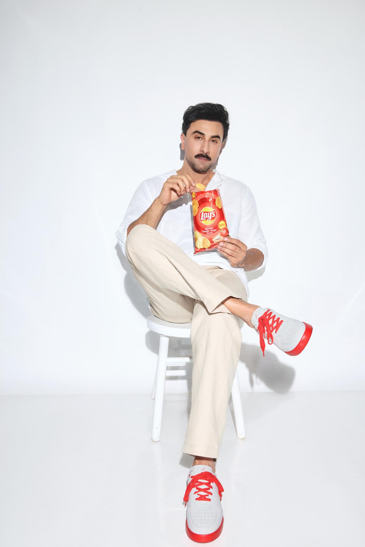 Ranbir Kapoor poses with Lay’s Spanish Tomato Tango and the pair of shoe inspired by it Ranbir Kapoor poses with Lay’s Spanish Tomato Tango and the pair of shoe inspired by it