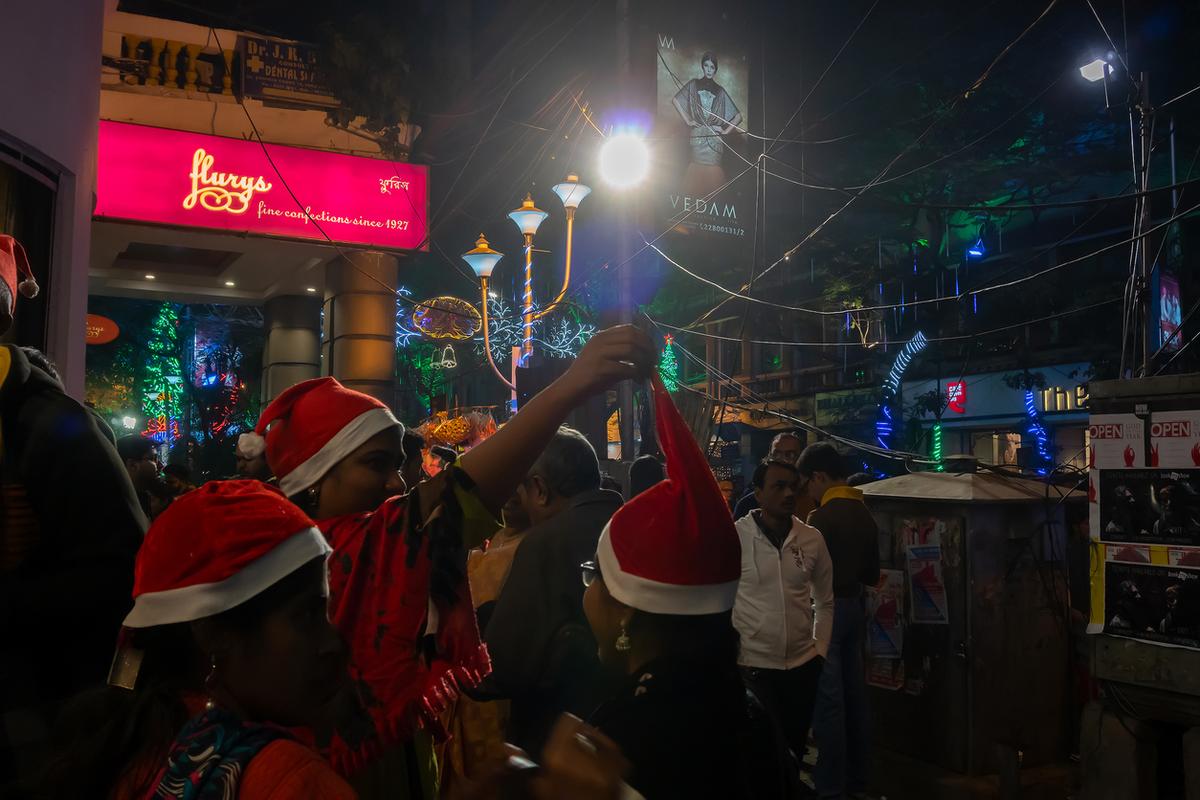 People enjoying themselves at a decorated street.