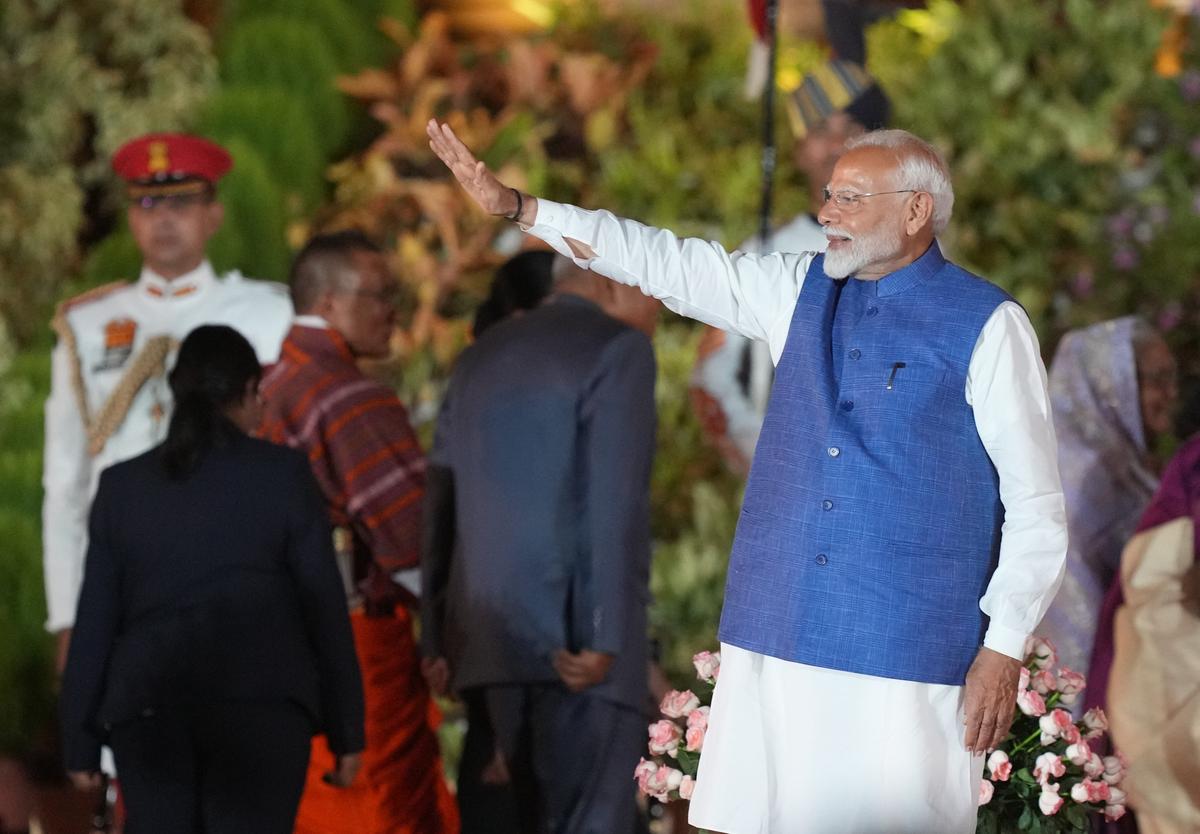 Prime Minister Narendra Modi waves after taking oath, at Rashtrapati Bhavan