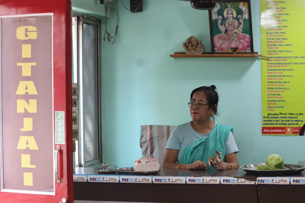 Bimola Devi sifting through dried heiribob peel 