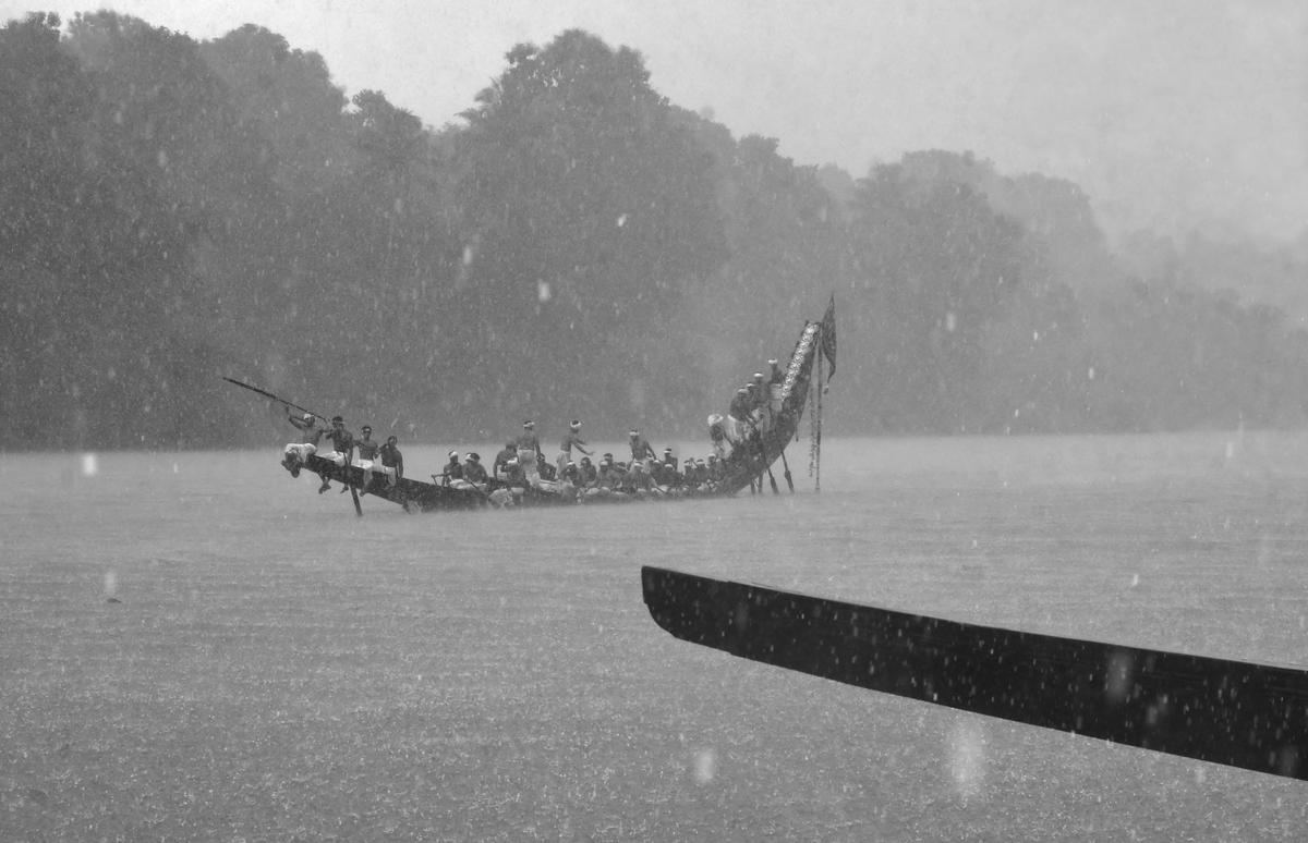 Oarsmen row a palliyodam (snake boat) in the Aranmula Uthrattathi Boat Race