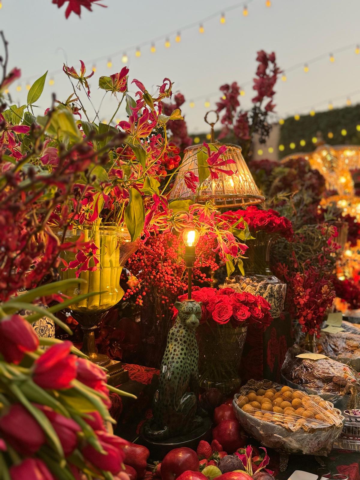 Devika Narain used gloriosa with tiny red apples and pomegranate on branches around the faux taxidermy panther and leopard Devika Narain used gloriosa with tiny red apples and pomegranate on branches around the faux taxidermy panther and leopard