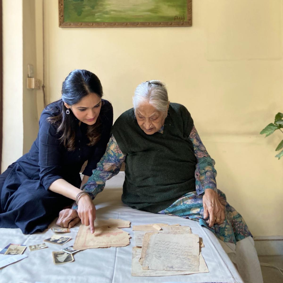 Aanchal scrutinizes old documents with her grandmother;  Photo: Special Arrangements