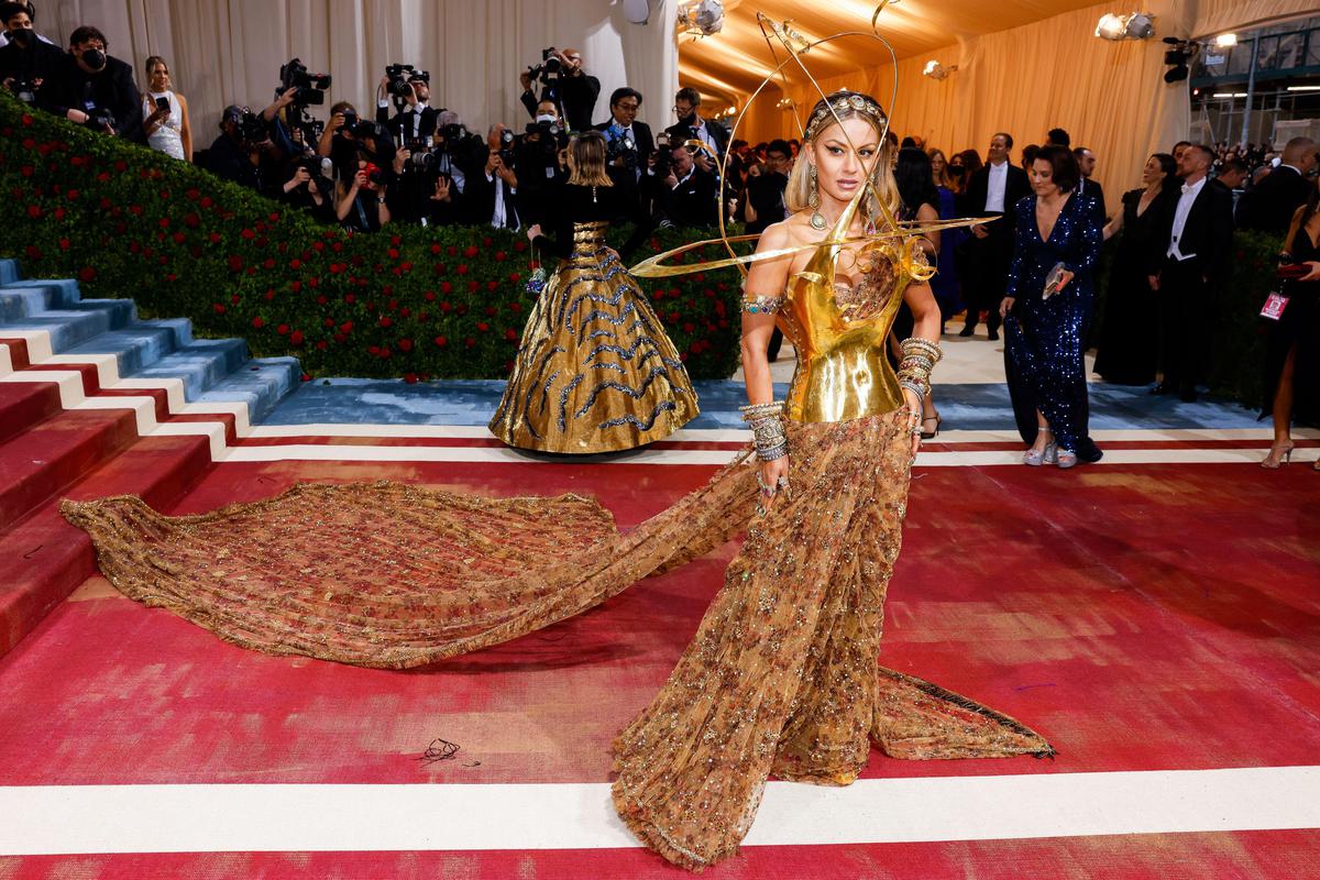 Natasha Poonawalla teamed a Sabyasachi embroidered sari with a metallic Schiaparelli bustier at the 2022 Met Gala