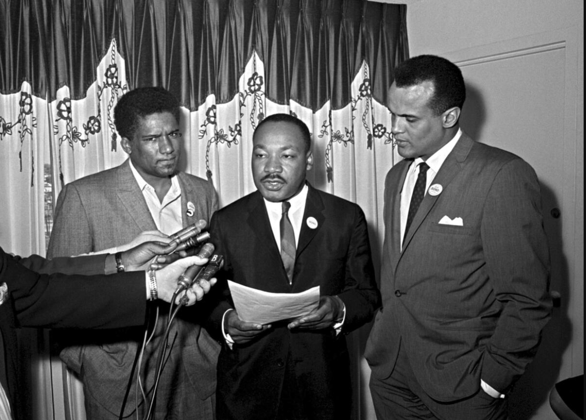Harry Belafonte (right) with Dr. Martin Luther King Jr. (center) at a press conference in Atlanta in 1965
