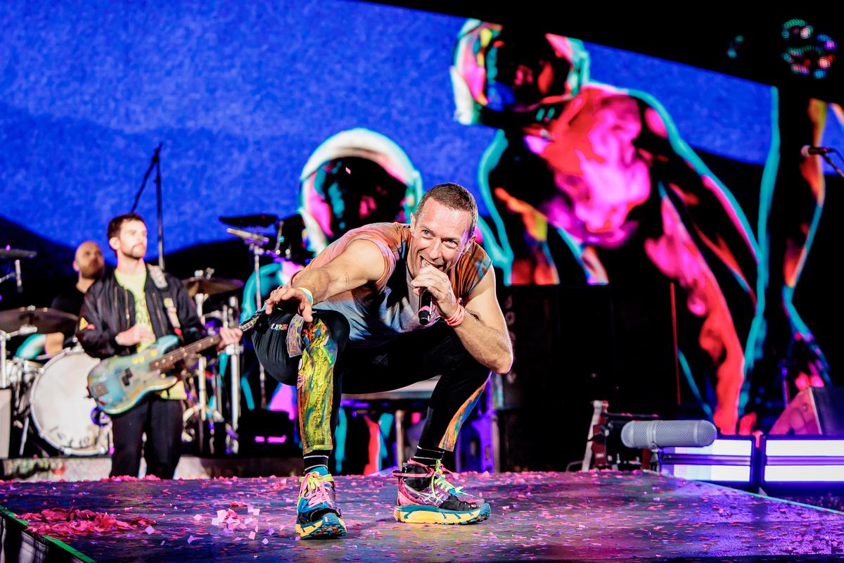 Will Champion, Guy Berryman and Chris Martin of Coldplay perform at Stadio San Siro in Milan