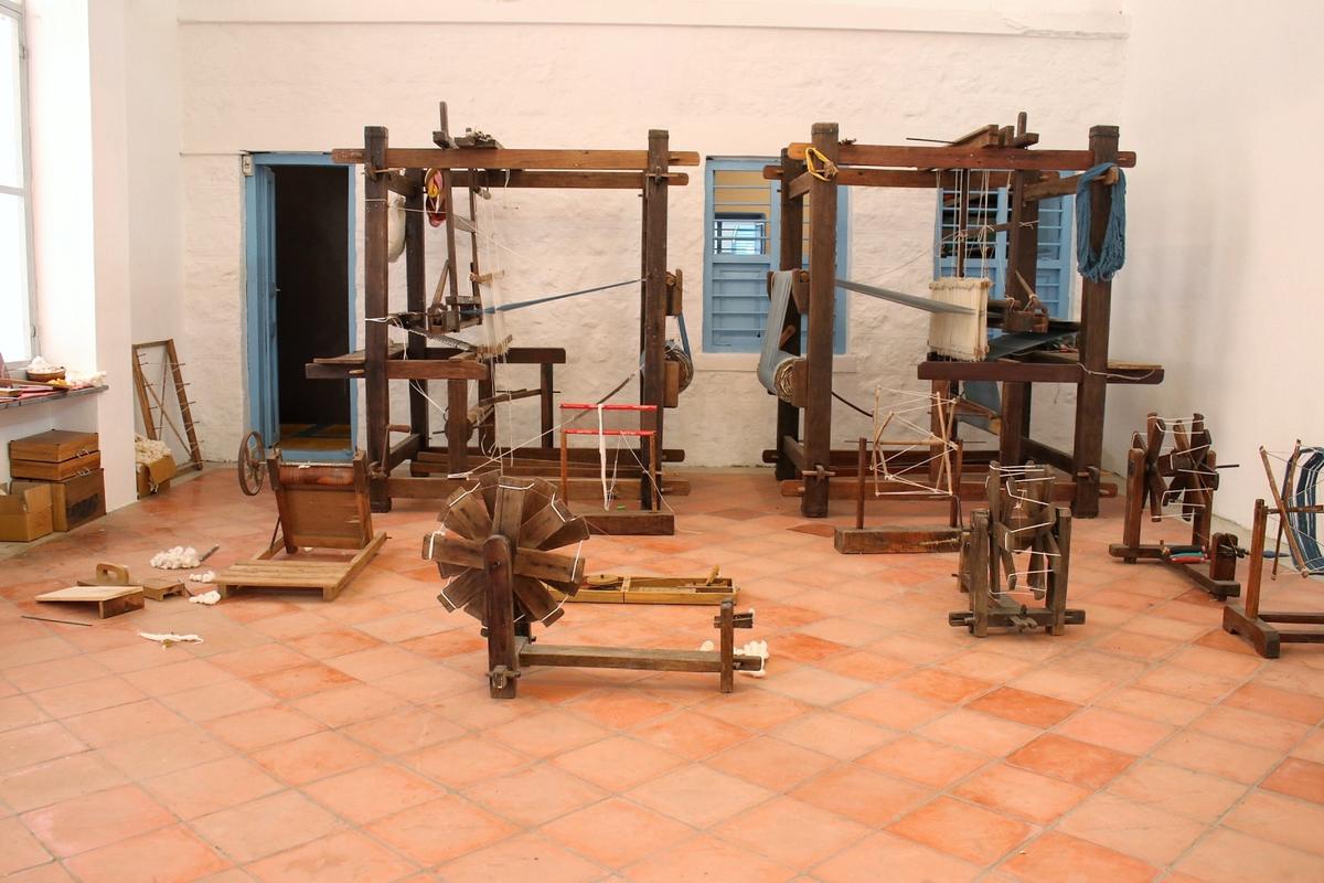 The ancient teakwood frame looms and charkas at the school