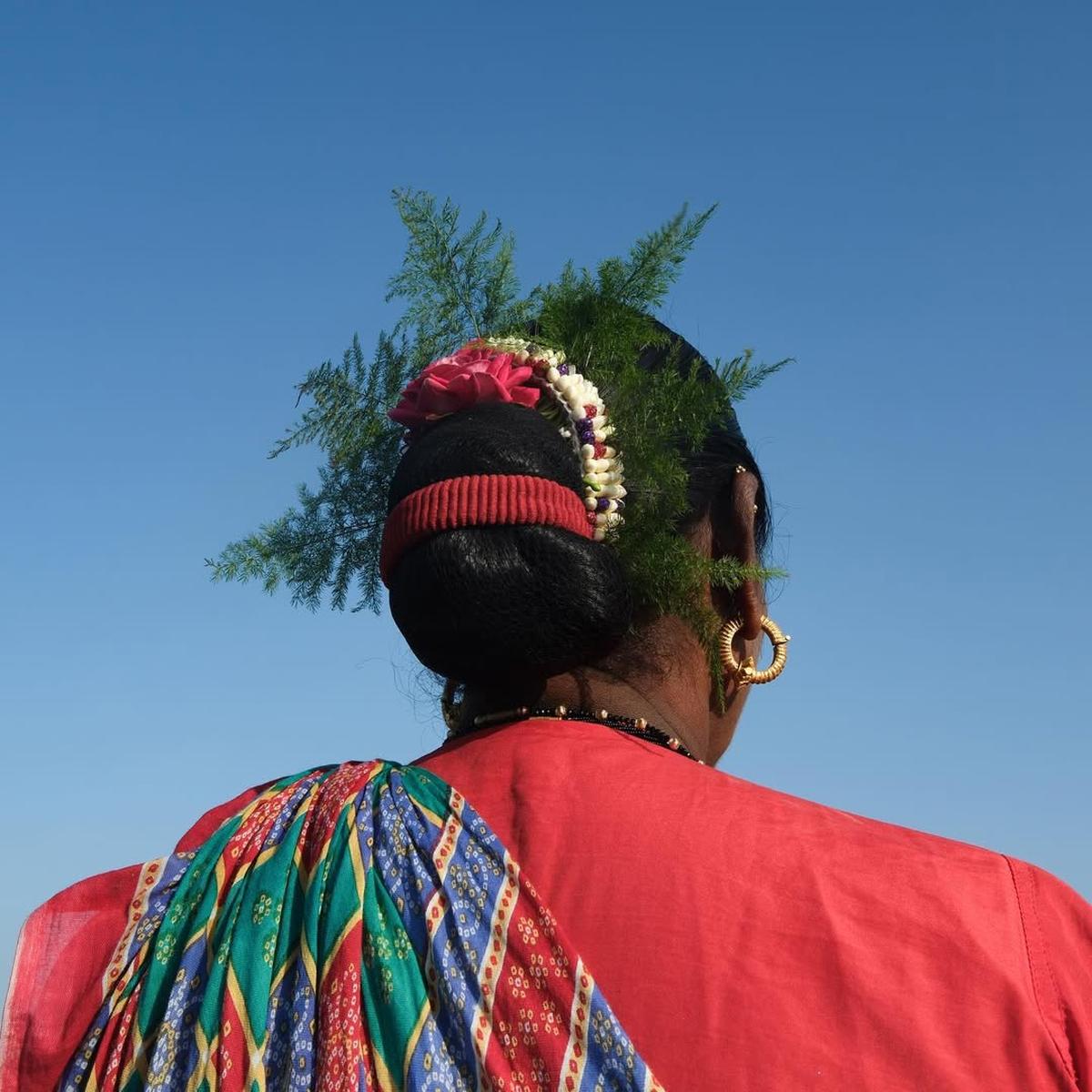 The women sport handmade gajras with flowers picked from their backyards
