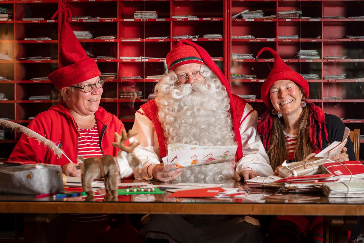 Santa Claus with elves at the post office at the Arctic Circle in Rovaniemi 