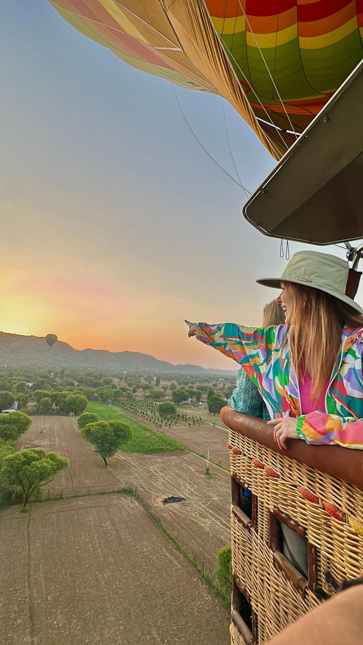 A tourist flies with Skywaltz Balloon Safari in Jaipur