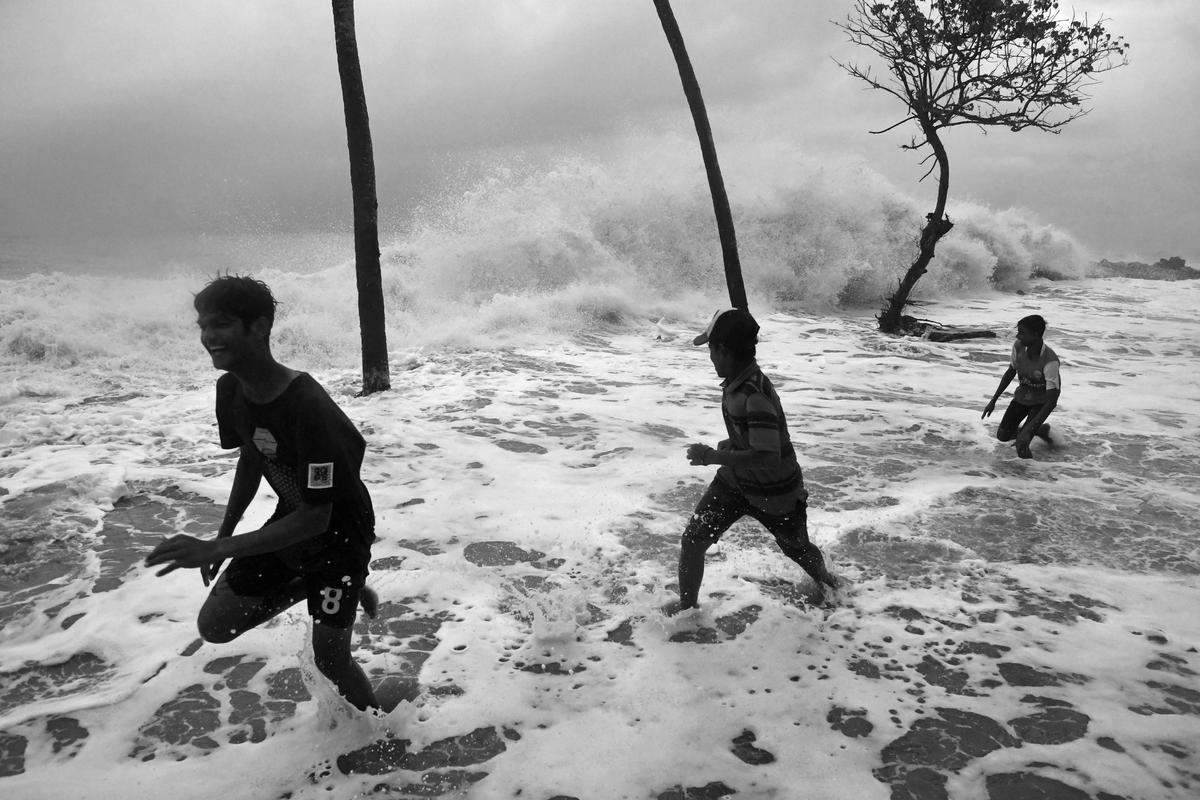 Children play in the heavy surf at Chellanam beach