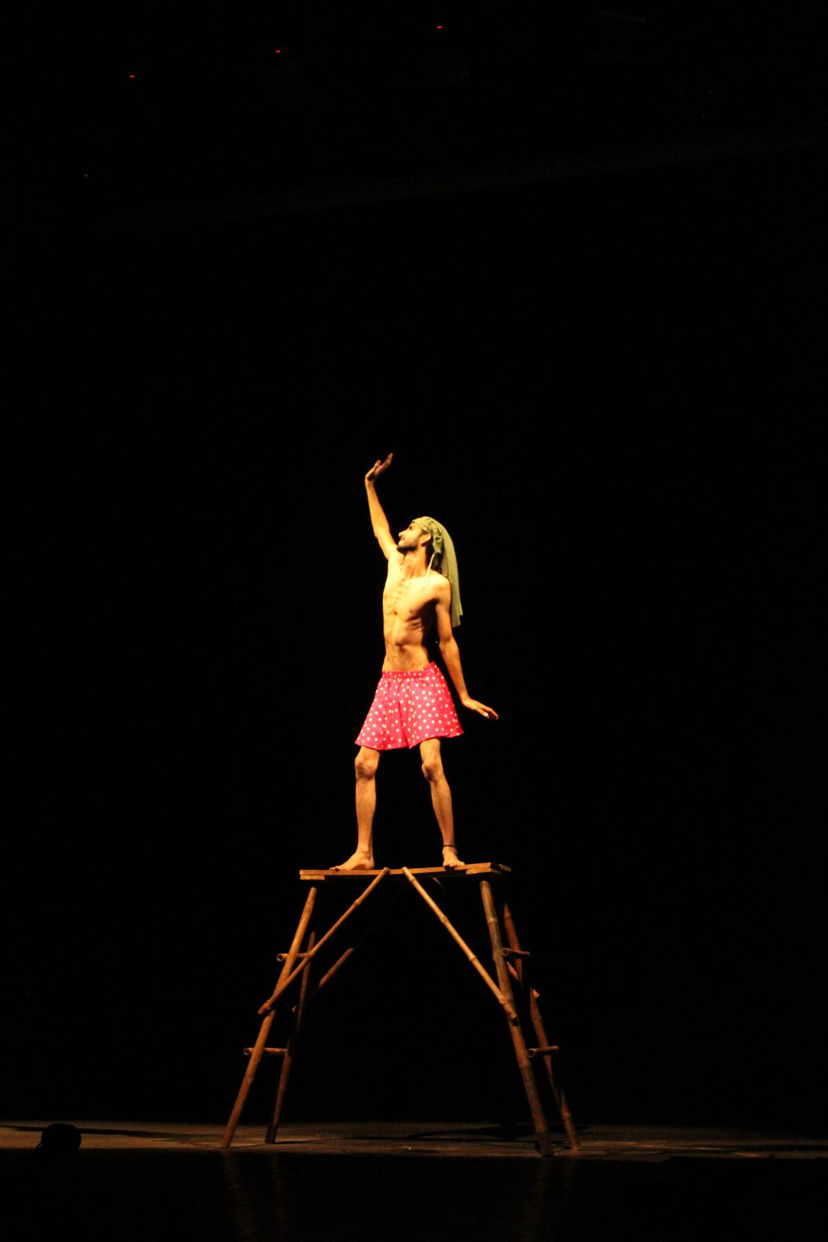 An actor strikes a pose during a performance of The Cage. 