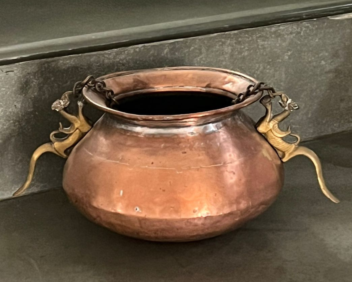 An embellished copper pot