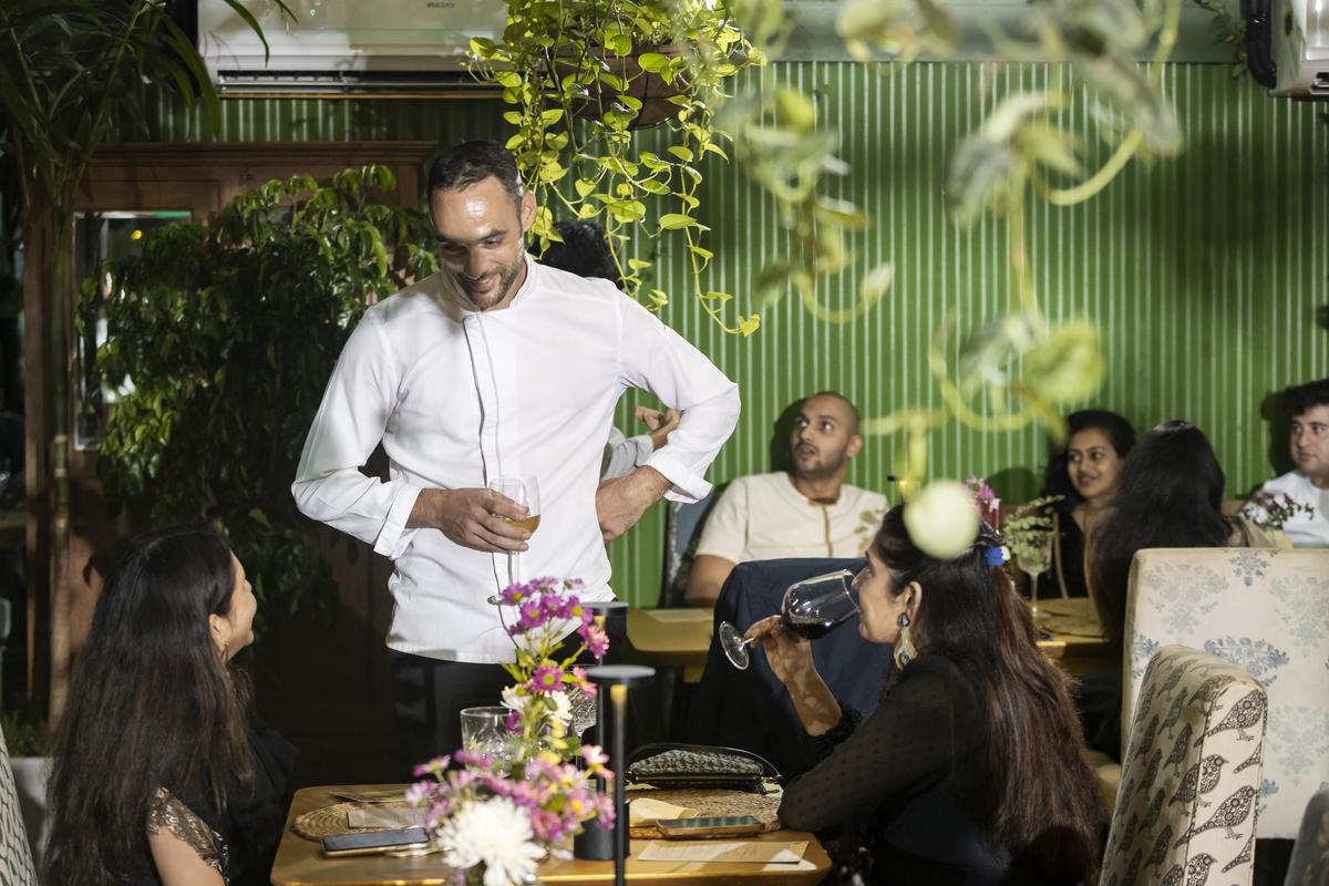 Chef Michel Christmann with diners at a meal curated by Chefs-à-Porter
