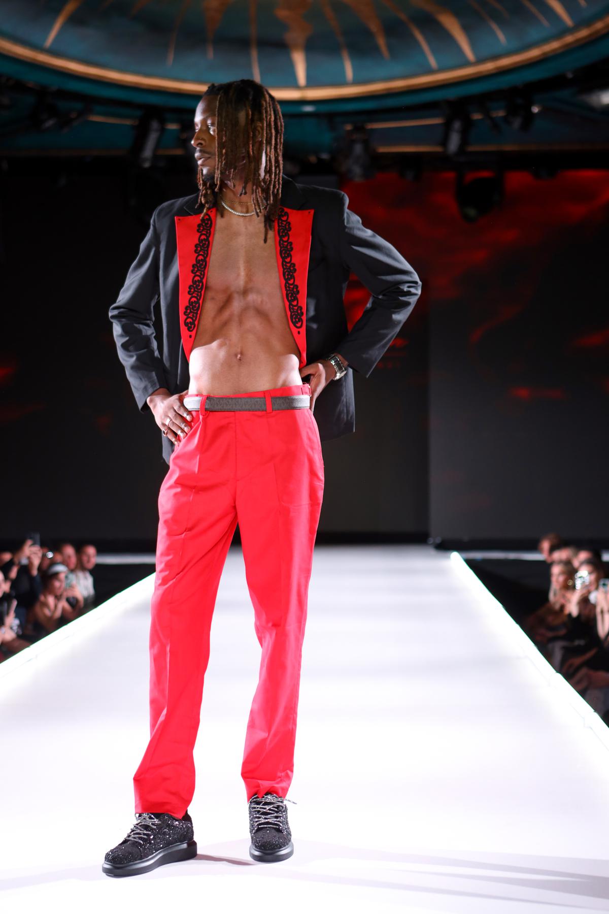 A male model flaunts Anaar shoe while walking the ramp for Kayzie Couture