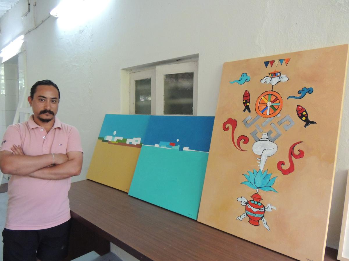 Bijaya Maharjan standing next to his compositions inspired by Chennai