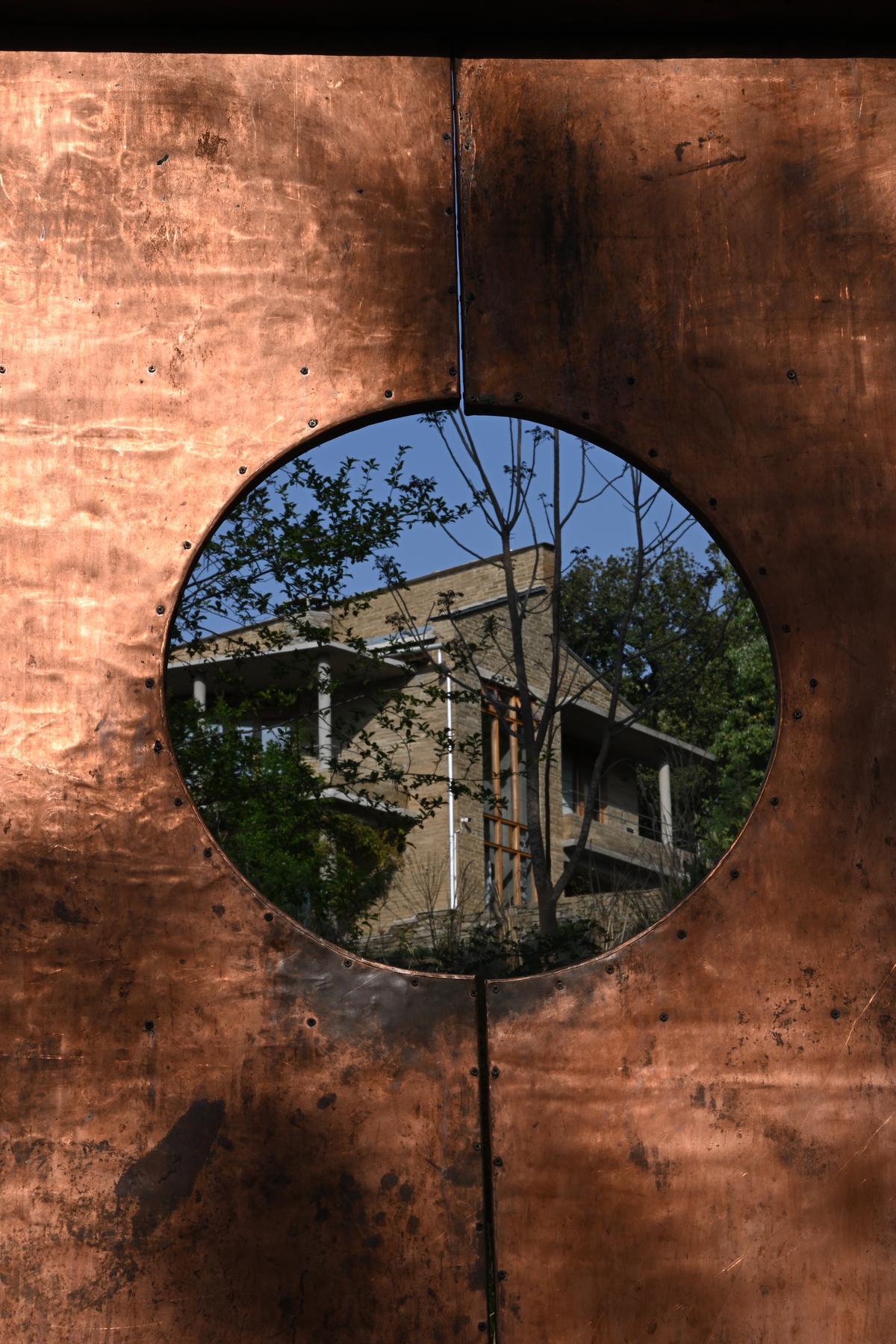 Spacehouse Himalayas’ stone facade seen through the copper entrance door designed by Brooklyn-based industrial designer Angie Kim.