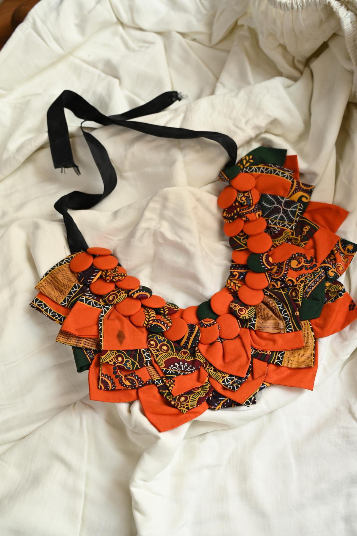 The bright orange Shweshwe fabric necklace from Cape Town.