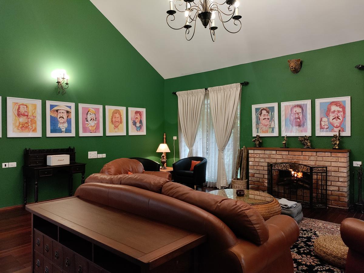 The living room with illustrations of a few of Mohanlal’s many film personas