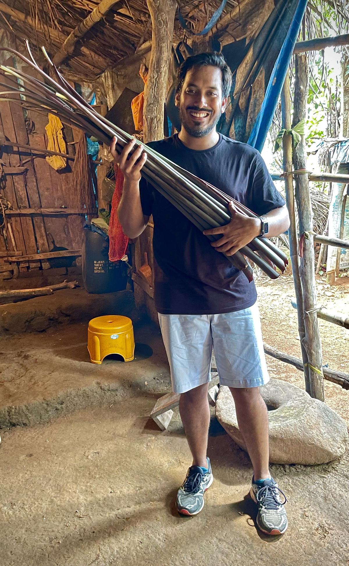 Zacharias holding a wild taro stolon in Cotigao, Goa