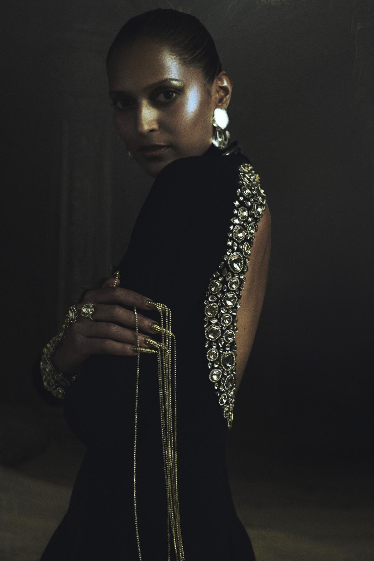 Embellished gloved sleeves, beaded pallus, and a signature ear cuff that doubles as a strap elevates the pieces into sculptural expressions