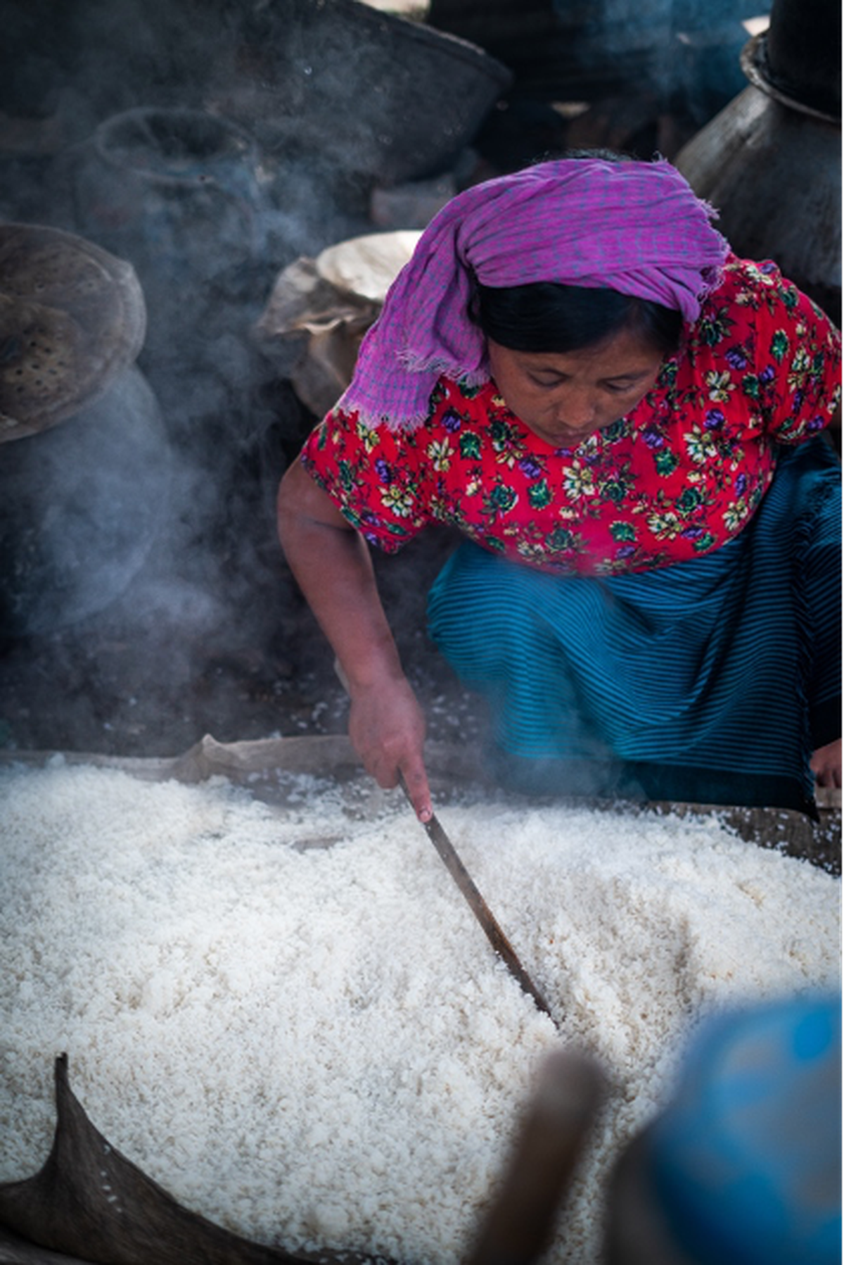 A woman preparing rice to brew alcohol