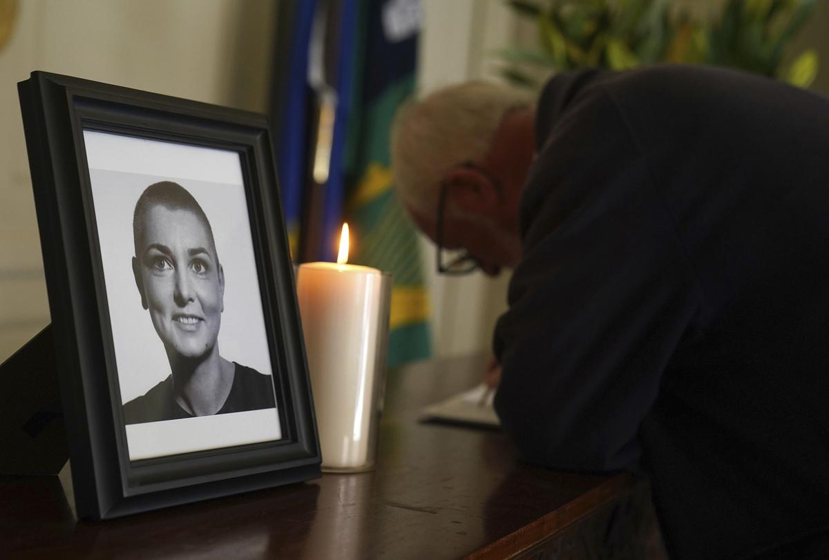 A person signs a book of condolence for Sinead O’Connor at the Mansion House in Dublin