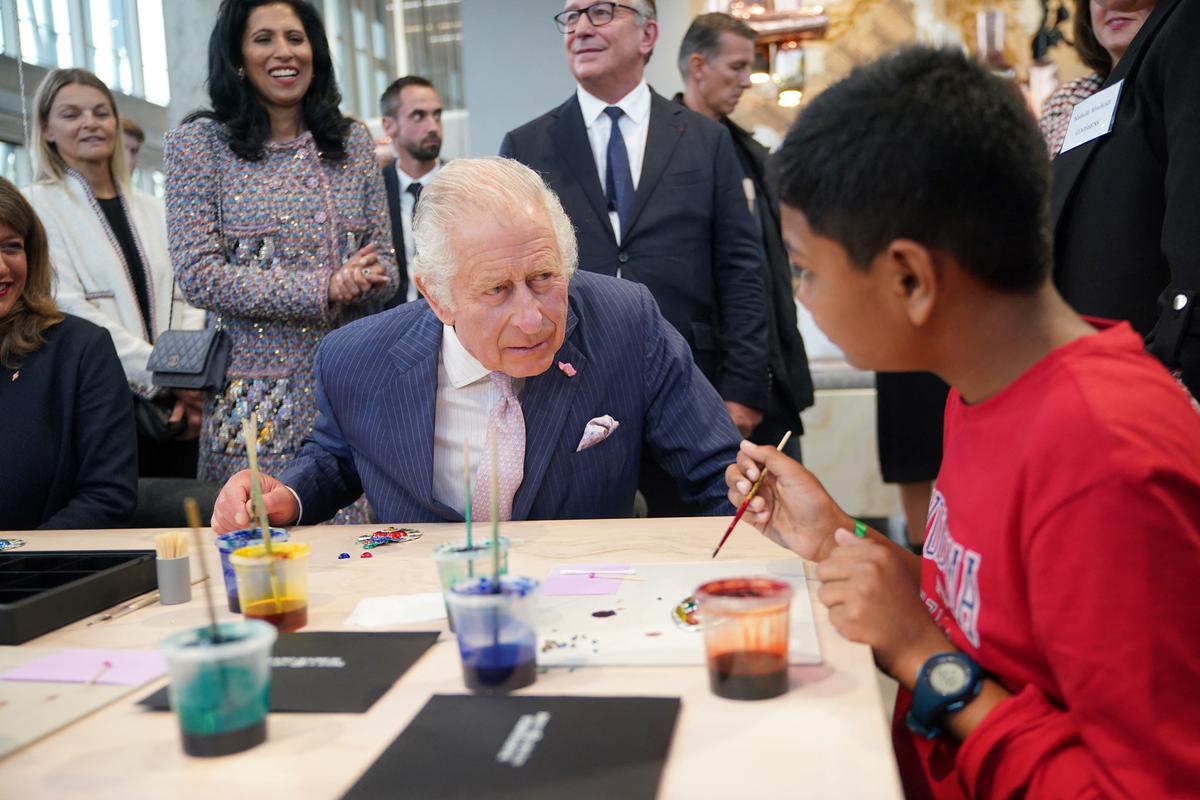 Leena Nair and Bruno Pavlovsky, president of fashion at Chanel, with King Charles III during a visit to the 19M Campus in Paris.