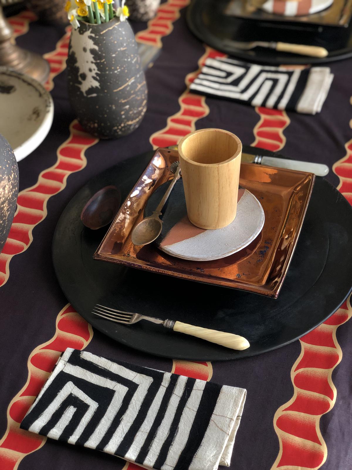 Black kadappa stone platters and copper lustre glazed square ceramic plates