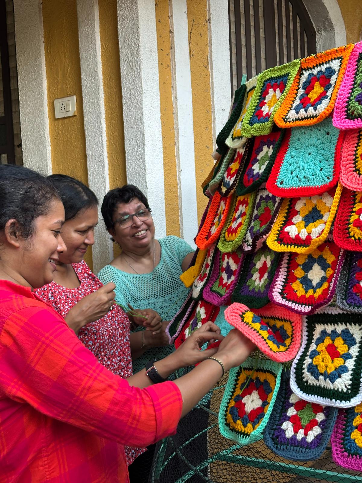 All the artists painstakingly attach squares to craft the 1,000-piece crochet tree, for the Where We Gather exhibit for the Festivals of Goa, MOG All the artists painstakingly attach squares to craft the 1,000-piece crochet tree, for the Where We Gather exhibit for the Festivals of Goa, MOG