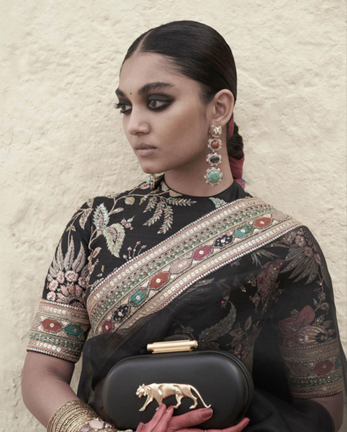 Statement earrings from the Bengal Byzantine Broadway collection, worn with an organza sari, and the Royal Bengal Minaudière from Sabyasachi Accessories