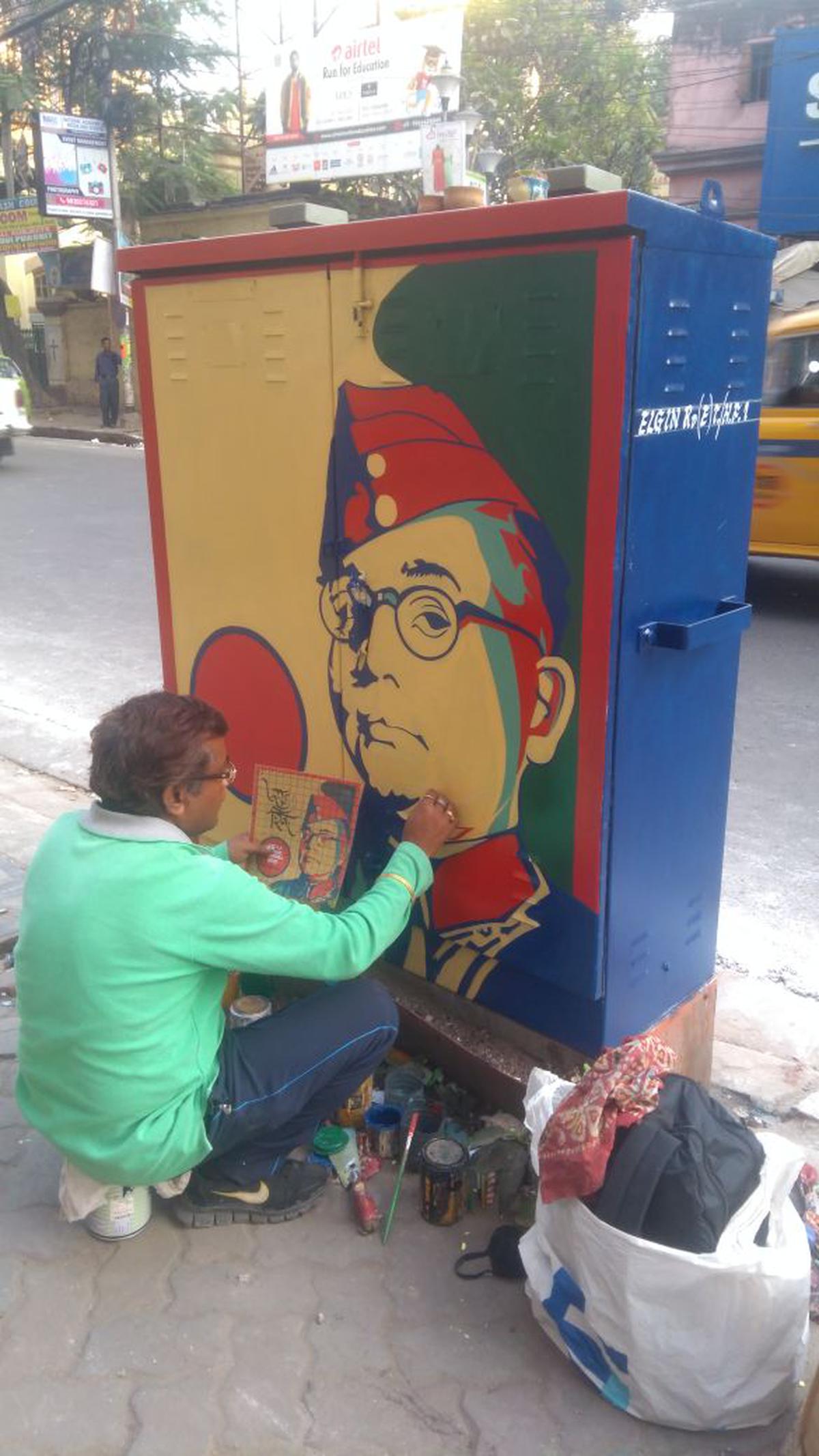 Mudar Patherya painting an electric feeder box