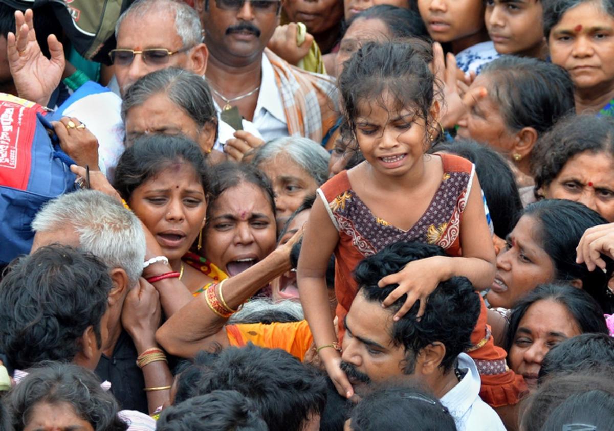 Devotees caught in a stampede near Pushkar Ghat as a sea of humanity thronged to take a dip in the river Godavari on the first day of Maha Pushkaram at Rajahmundry in Andhra Pradesh.