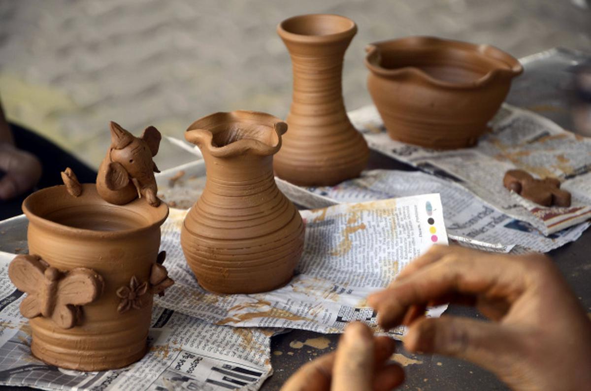 Premium Photo  Freshly made clay pot on a potters wheel